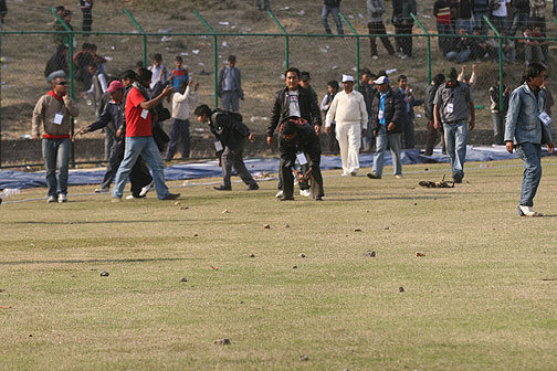 CROWD TROUBLE: Volunteers clean up ground after crowd trouble. Photo by NepalSportsPhoto.com