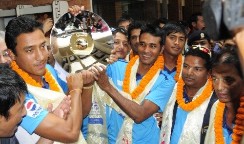 Nepali national cricket team poses for a photo  at the Tribhuwan  International Airport  on its arrival in Kathmandu after winning the World Cricket League Division 4 held in Malaysia in September.