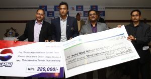 (L-R) Unit Manager of Varun Beverage Rohit Kohli, Nepal captain Paras Khadka, Standard Chartered Bank CEO Joseph Silvanus and Head of Corporate Affairs Diwakar Paudel pose for a photo after handing over cheques to the Nepal Cricket Team.