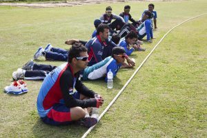 Nepali National team sits on the boundary watching U-19 regional cricket tournament. They didn't get to train properly. Photo: Bikas Karki