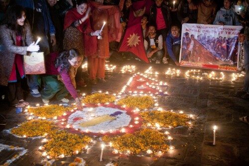 Himali Khadka, mother of Sharad Veshwakar, and other cricket lovers lights oil lamp at Pashupati to celebrate and pray for Team Nepal. Nepal qualifyed for the ICC World T20, beating Hong Kong by five wicket in ICC World T20 Qualifiers match in Abu Dhabi on Wednesday, 27th November. Photo: Bikash Karki